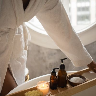 A water bottle and a small towel next to a window.