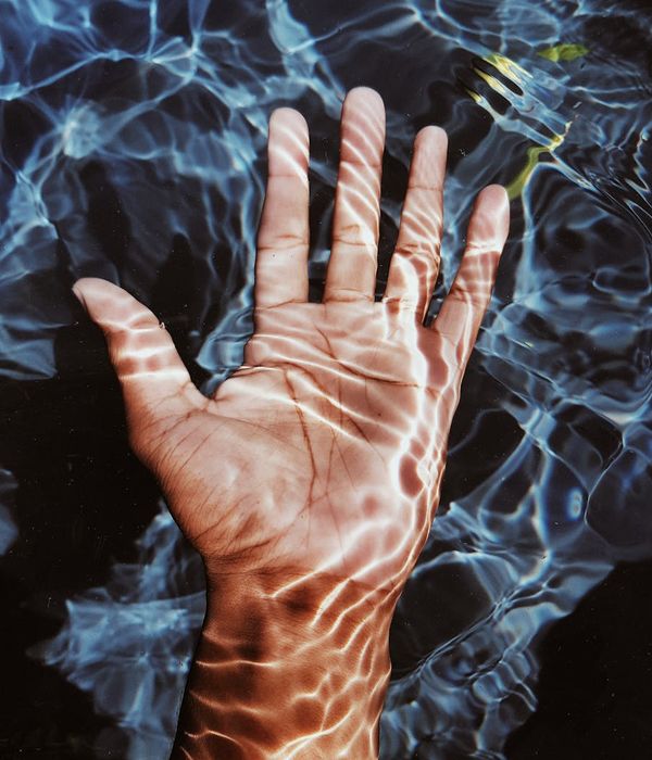 Person doing a fluid stretching motion in a minimalist room.